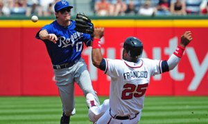 Chris Getz of the Kansas City Royals turns a double play against Atlanta's Juan Francisco
