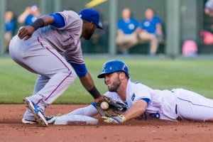 KANSAS CITY, MO - JUNE 05: Mike Moustakas #8 of the Kansas City Royals attempts to avoid the tag at second base from Hanser Alberto #68 of the Texas Rangers in the first inning at Kauffman Stadium on June 5, 2015 in Kansas City, Missouri. Moustakas was called safe initially but after review was called out. (Photo by Kyle Rivas/Getty Images)