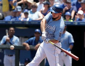 Kansas City Royals' Eric Hosmer hits a sacrifice fly to score Alcides Escobar during the first inning of a baseball game against the Texas Rangers, Sunday, June 7, 2015, in Kansas City, Mo. (AP Photo/Charlie Riedel)