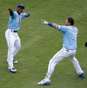 Kansas City Royals' Jarrod Dyson and Paulo Orlando (16) celebrate after Orlando hit a walk-off grand slam during the ninth inning of the first game in a baseball doubleheader against the Tampa Bay Rays Tuesday, July 7, 2015, in Kansas City, Mo. The Royals won 9-5. (AP Photo/Charlie Riedel)
