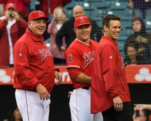 Angels manager Mike Scioscia and team general manager Jerry Dipoto stand with Mike Trout as he recieves the 2012 Rookie of the Year honor at Angel Stadium Saturday night. Trout was the second Angel to get the honor since Tim Salmon in 1993. ///ADDITIONAL INFO: hsmaya.0413 - 4/13/13 - ROD VEAL, ORANGE COUNTY REGISTER - The Angels take on the Houston Astros at Angel Stadium Saturday night.