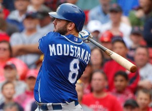 Kansas City Royals' Mike Moustakas follows through on a two-run double against the Boston Red Sox during the ninth inning of a baseball game at Fenway Park in Boston Sunday, Aug. 23, 2015. (AP Photo/Winslow Townson)