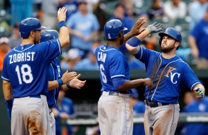 Kansas City Royals' Mike Moustakas, right, celebrates his grand slam with teammates Ben Zobrist (18), Kendrys Morales and Lorenzo Cain (6) in the seventh inning of a baseball game against the Baltimore Orioles, Saturday, Sept. 12, 2015, in Baltimore. (AP Photo/Patrick Semansky)