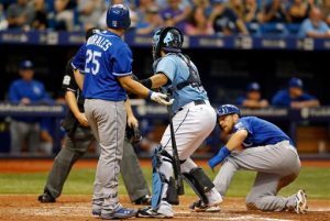 Tampa Bay Rays catcher Rene Rivera, second from right, tags out batter Kansas City Royals' Kendrys Morales (25) after tagging out Royals' Ben Zobrist, right, to complete a double play during the eighth inning of a baseball game Sunday, Aug. 30, 2015, in St. Petersburg, Fla. The Rays won 3-2. (AP Photo/Mike Carlson)