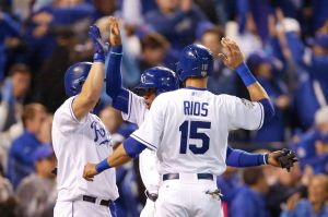 KANSAS CITY, MO - OCTOBER 28: Alcides Escobar #2 of the Kansas City Royals and Alex Rios #15 of the Kansas City Royals celebrate with Kendrys Morales #25 of the Kansas City Royals after scoring runs in the fifth inning against the New York Mets in Game Two of the 2015 World Series at Kauffman Stadium on October 28, 2015 in Kansas City, Missouri. (Photo by Sean M. Haffey/Getty Images)
